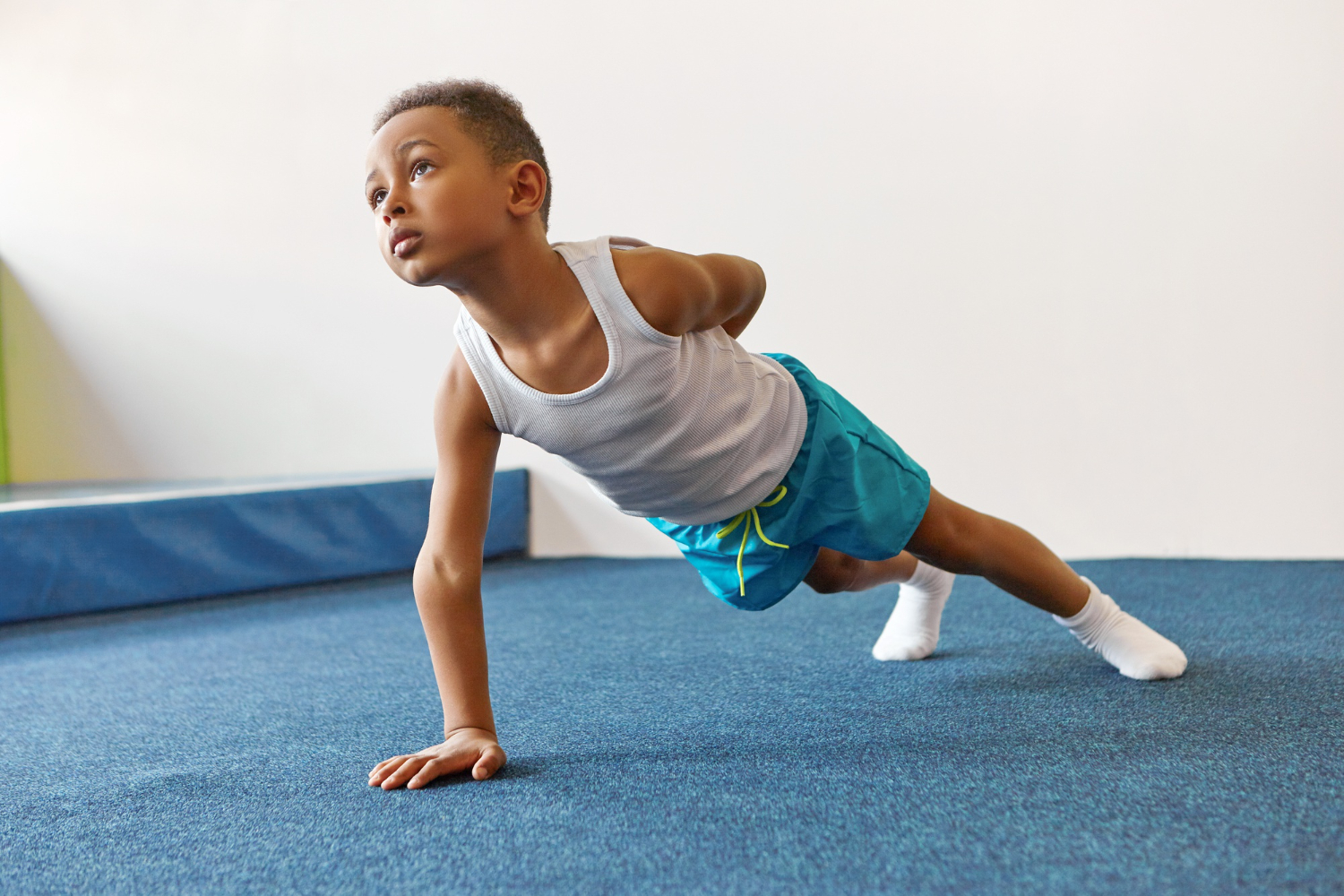 disciplined-skinny-african-american-kid-sportswear-doing-single-arm-plank.jpg