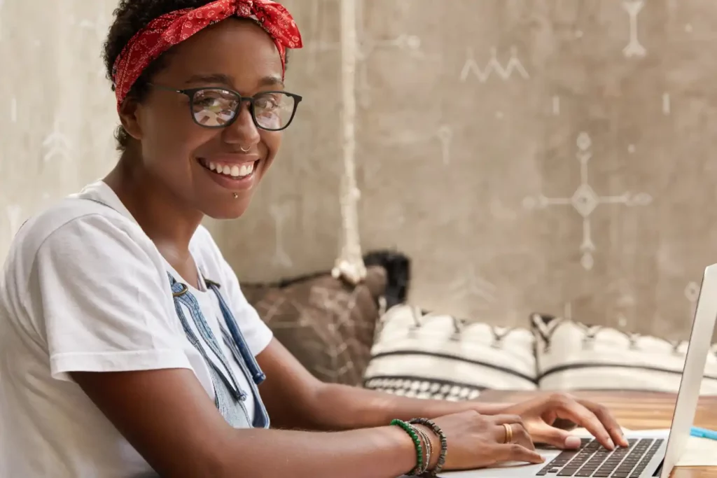 happy black woman with a laptop