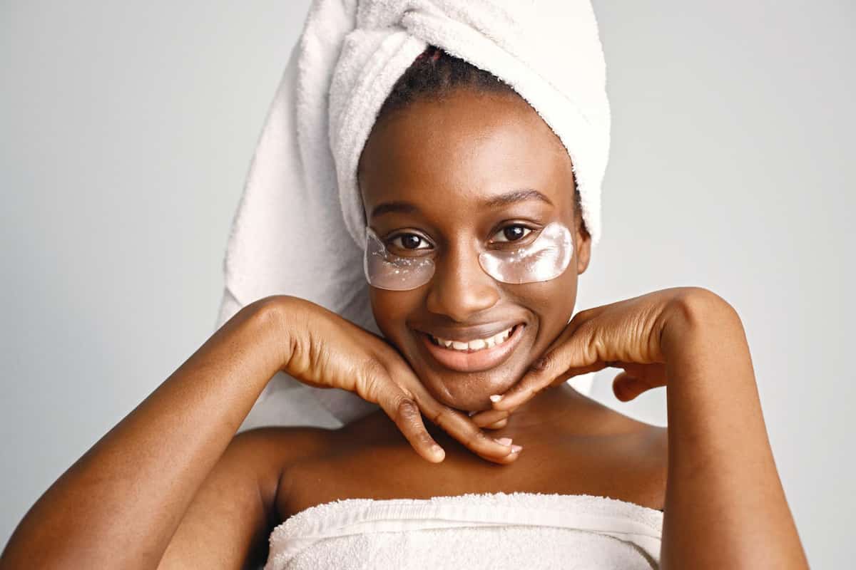 sportcovery-black-girl-with-towel-head-has-eye-patches-isolated-white-background-black skin
