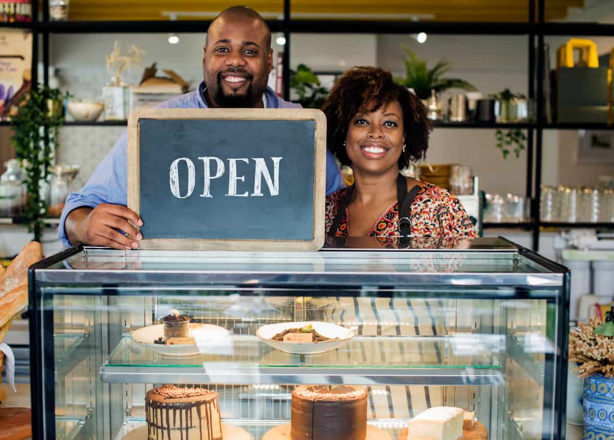 spotcovery-cake-cafe-owners-with-open-sign-black-owned-restaurants-in-orlando