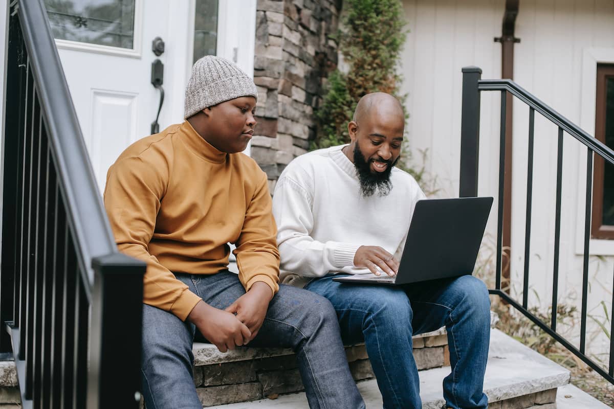spotcovery-cheerful-black-businessman-browsing-laptop-with-son-remote-jobs-with-lucrative-salaries