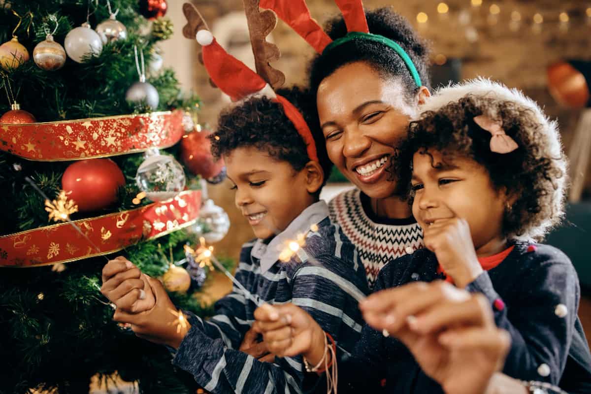 spotcovery-happy-african-american-family-using-sparklers-while-celebrating-christmas-home-black-santa-family