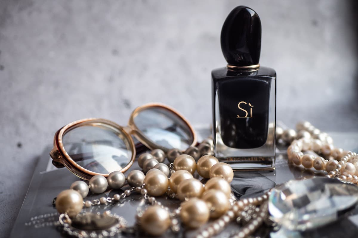 spotcovery-perfume-bottle-on-table-with-accessories-black-entrepreneurship-antique-and-vintage-reselling-business