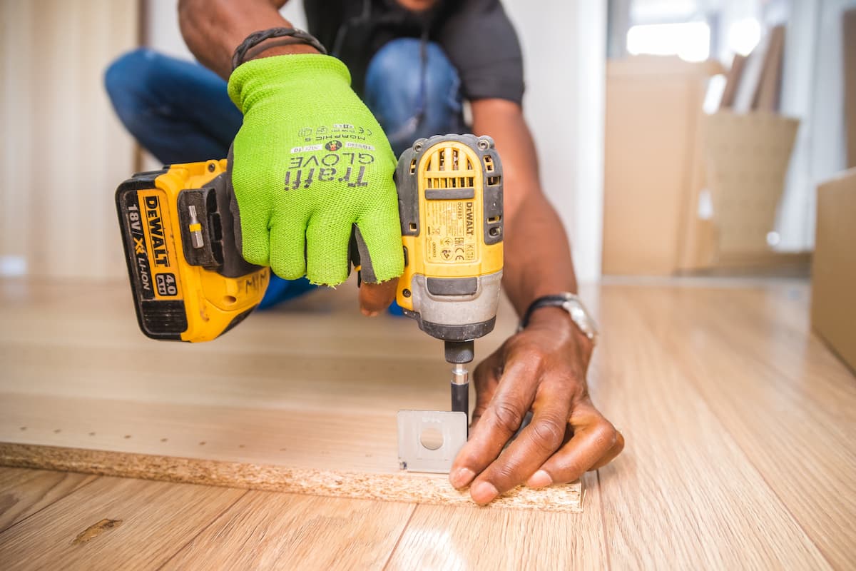 spotcovery-person-using-dewalt-cordless-impact-driver-how-to-start-handyman-business-as-a-black-entrepreneur