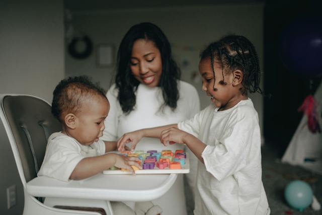 spotcovery-two-children-playing-blocks-with-a-parent-child-safety-protection-month-how-african-americans-can-keep-their-children-safe