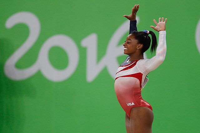 spotcovery-biles-doing-a-routine-at-the-2016-rio-olympics-simone-biles-the-talented-africa-american-and-world-champion-for-the-6th-time