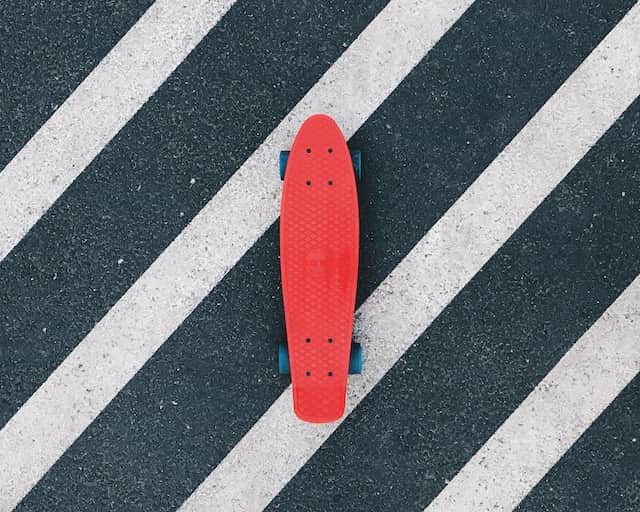 spotcovery-red-skateboard-on-a-black-and-white-road-beatrice-domond-trailblazing-skateboarder-breaking-barriers