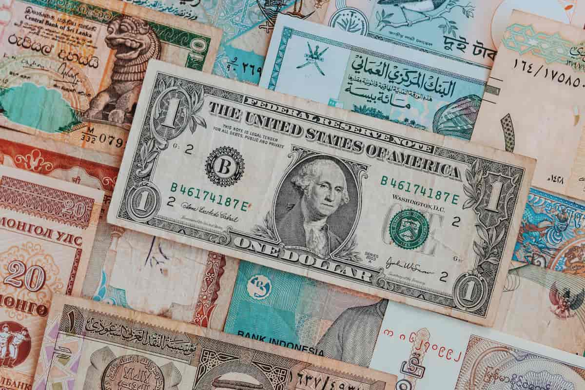 spotcovery-banknotes-with-dollar-bill-on-top-currency-worth-more-than-us-dollar-7-strong-currencies-black-travelers-should-know
