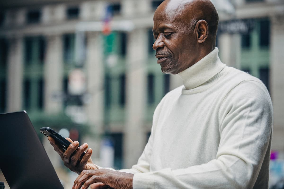 spotcovery-black-man-looking-at-his-bank-app-7-ways-to-become-financially-independent-as-african-american