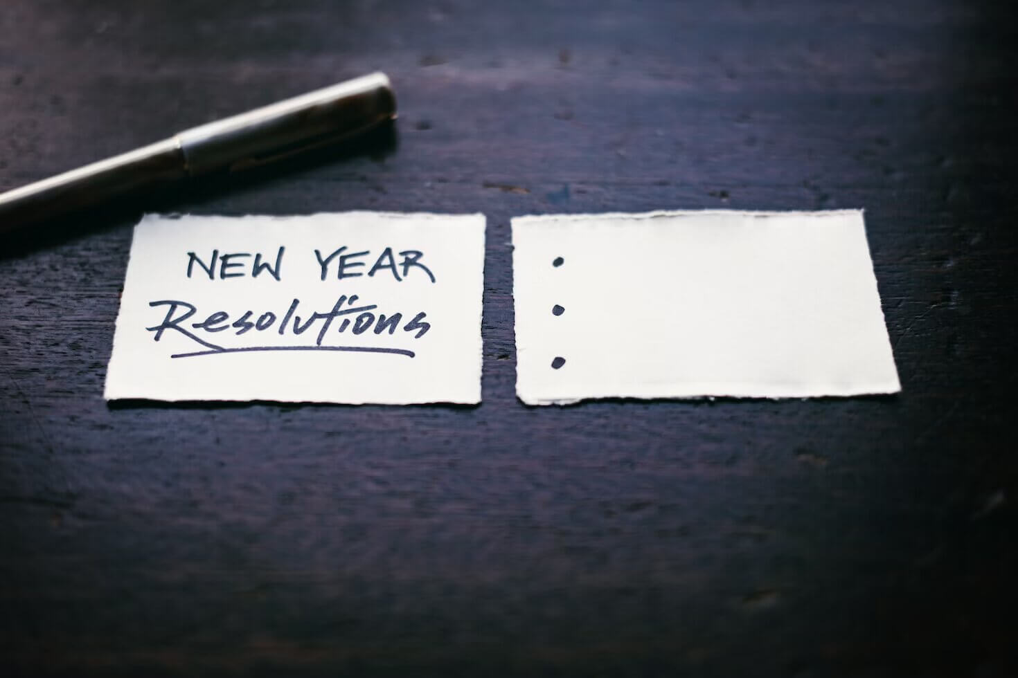 Spotcovery-New-year-resolutions-words-written-on-a-white-paper-New-year’s-resolution-for-couples