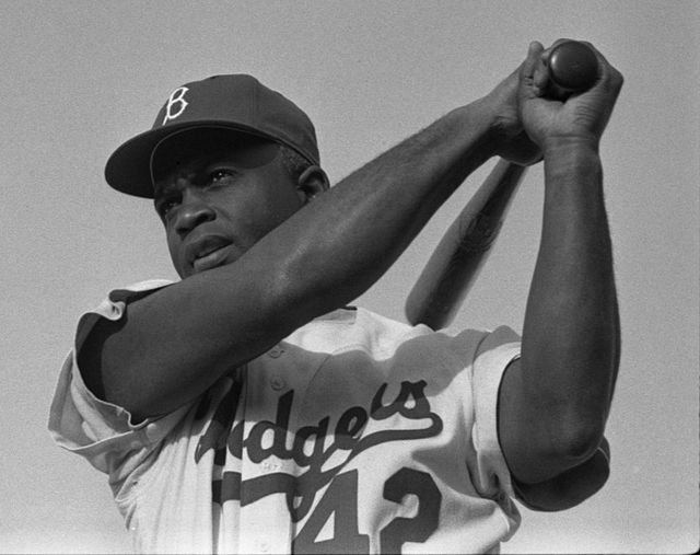 spotcovery-robinson-swinging-a-baseball-bat-how-jackie-robinson-became-the-first-black-man-to-play-in-the-mlb