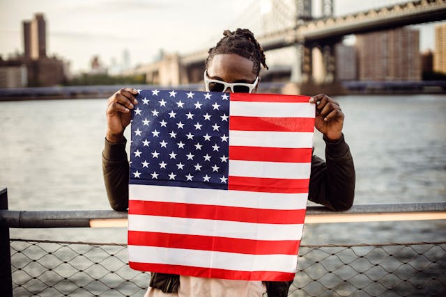 spotcovery-a-black-man-with-an-american-flag-12-memorable-4th-of-july-events-you-should-do-in-2024